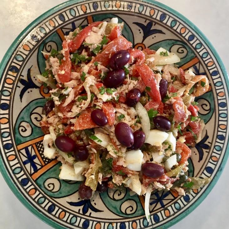 tuna salad with egg, olives and peppers