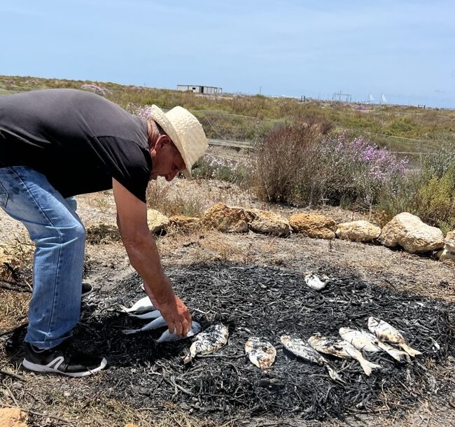 Man cooking seabream at the fish farm on the way to Jerez, part of Annie B Spain Almadraba and Sherry Tour