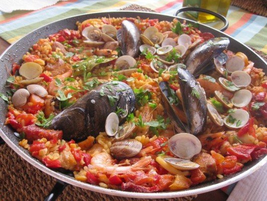 traditional seafood paella in pan
